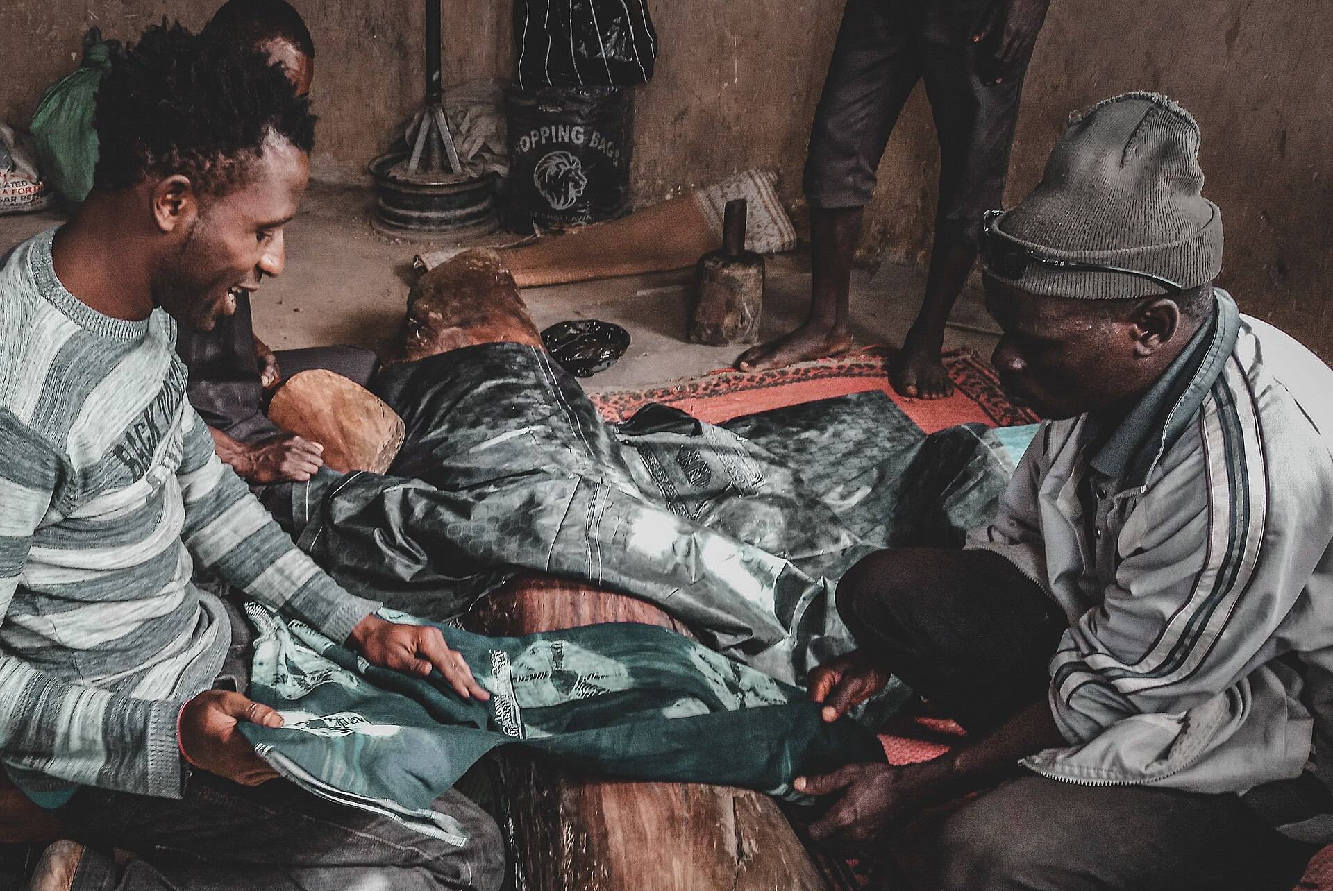 Craftsmen beating freshly dyed cloth at the Kofar Mata dye pits in Kano